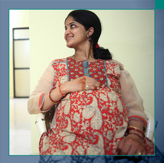 Woman carrying sleeping baby on back.